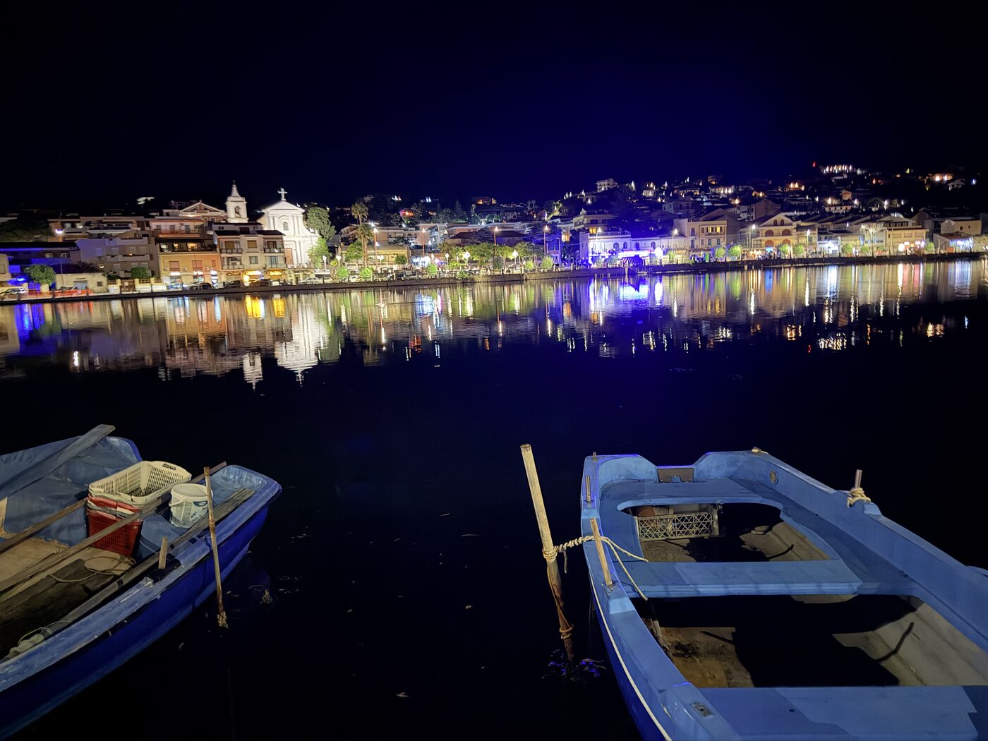 Illuminated waterfront reflected in the harbor