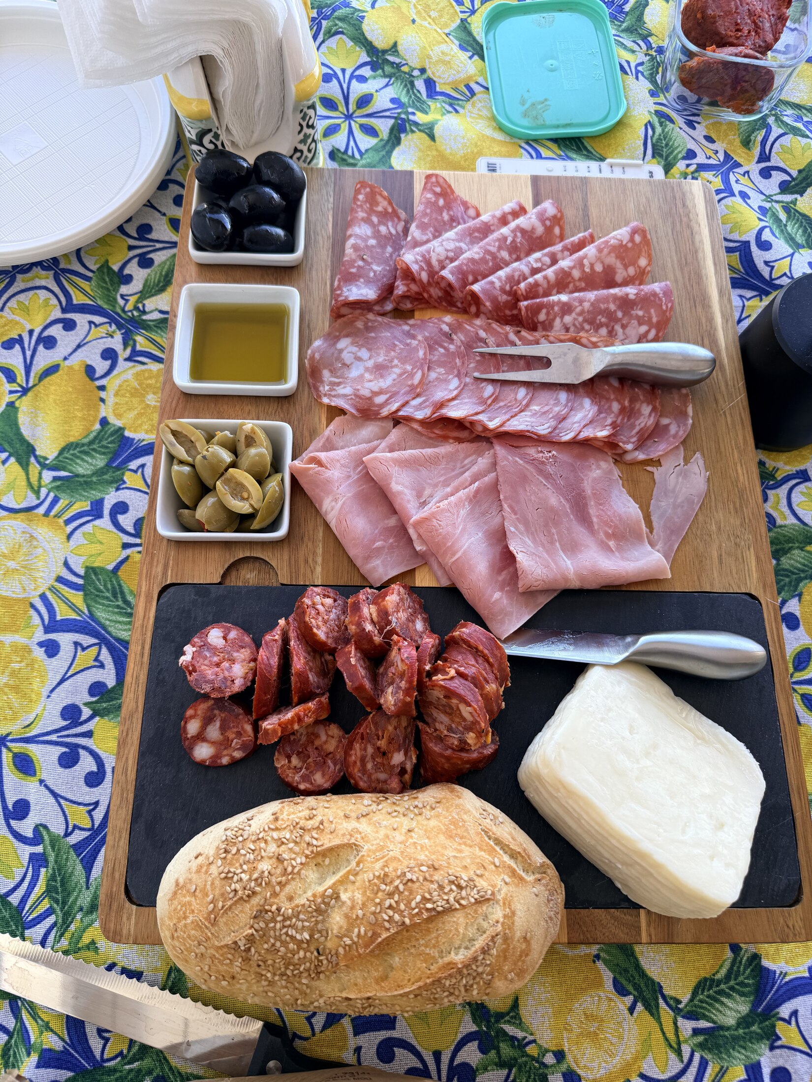A table set with Sicilian bread, cheese, olives and salumi